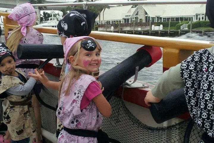 kids in pirate costumes on a boat