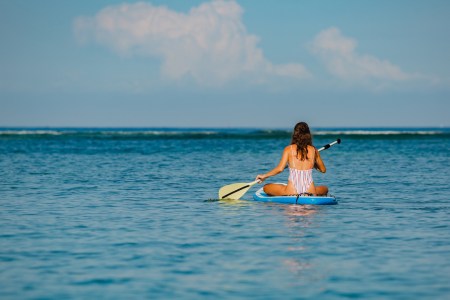 a person riding a surf board on a body of water