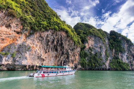 People on a boat tour with a beautiful mountain view