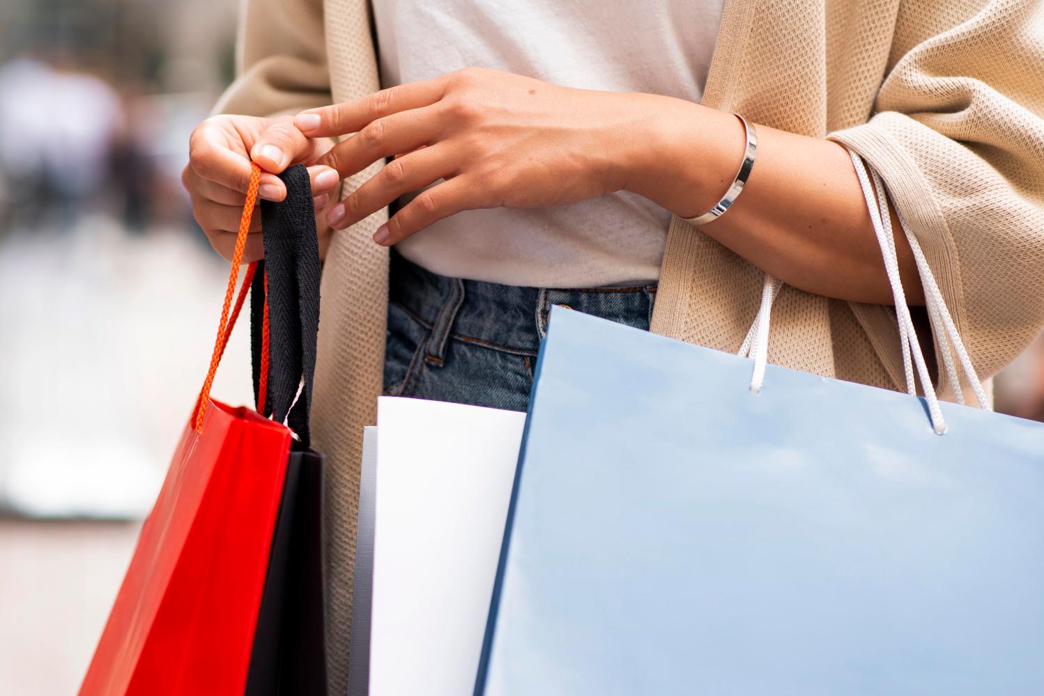 Woman carrying many shopping bags