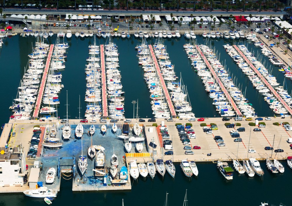 An aerial view of a dock full of boats and yachts