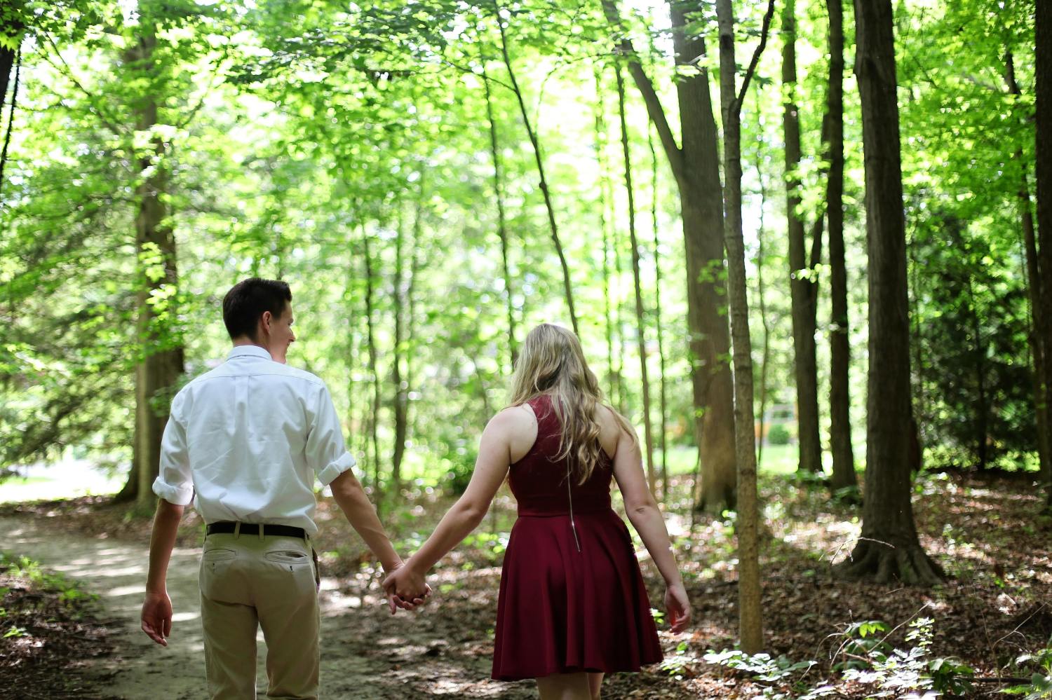 A couple walking in a park while holding hands