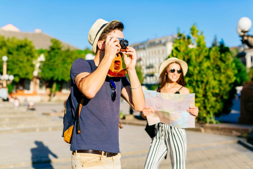 A young couple enjoying the beautiful attractions and sights of the area 